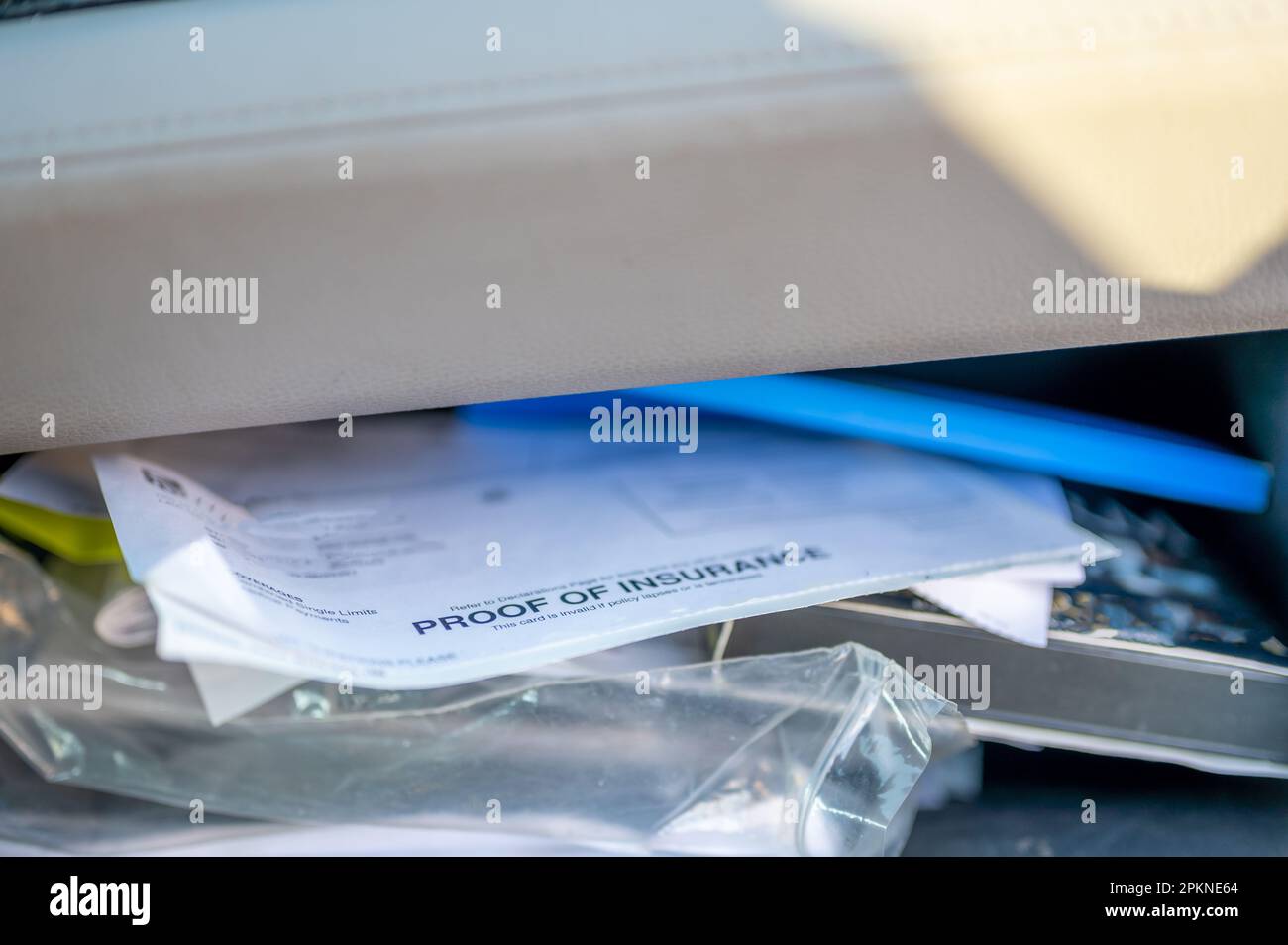 Proof of insurance and vehicle registration documents in the glove