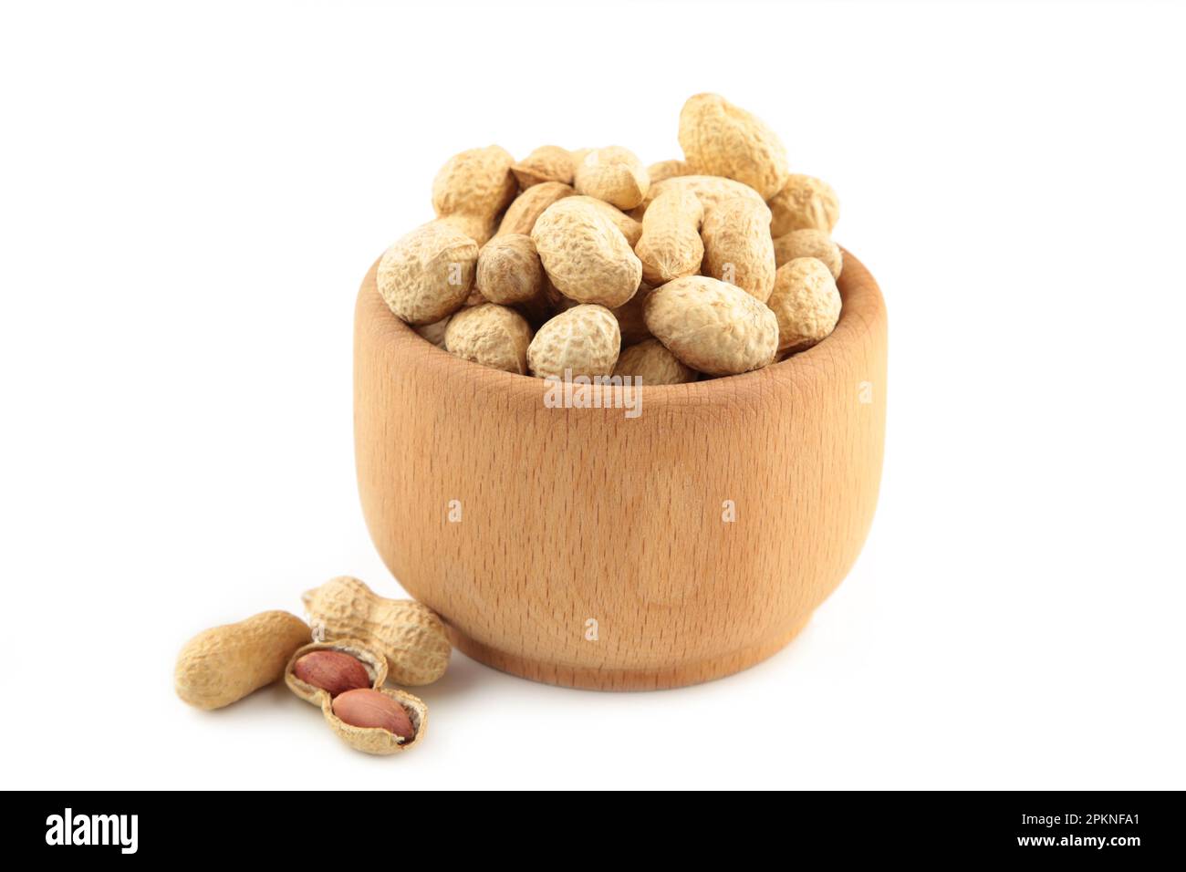 Dried peanuts in wooden bowl isolated on white background. Top view Stock Photo