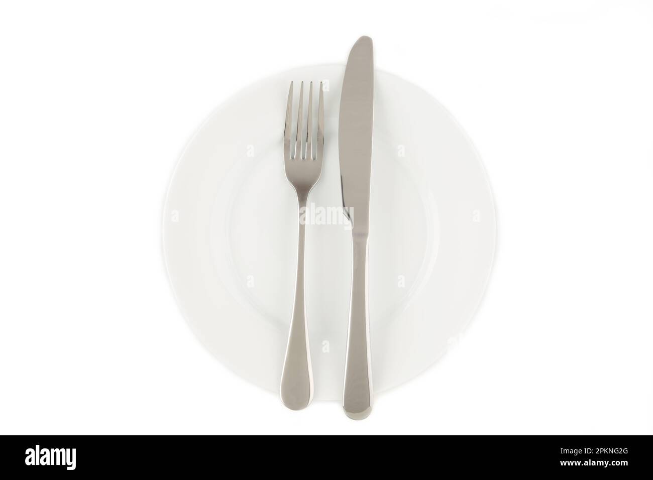 Dining etiquette - the meal is over or finished. Fork and knife signals with location of cutlery set. Photo isolated on white background. Set of foto Stock Photo