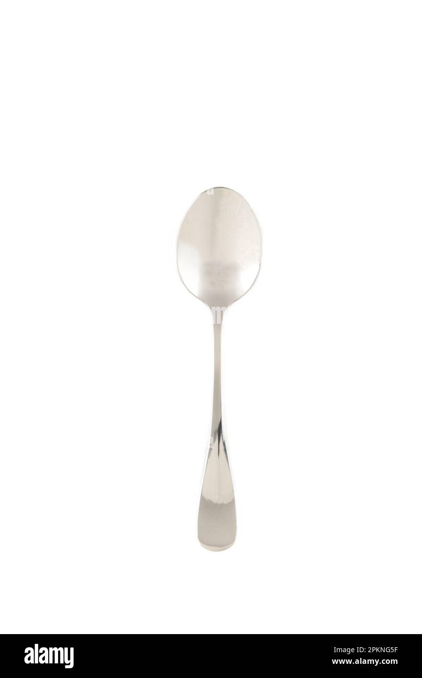 Little silver spoon isolated on white background. Top view Stock Photo