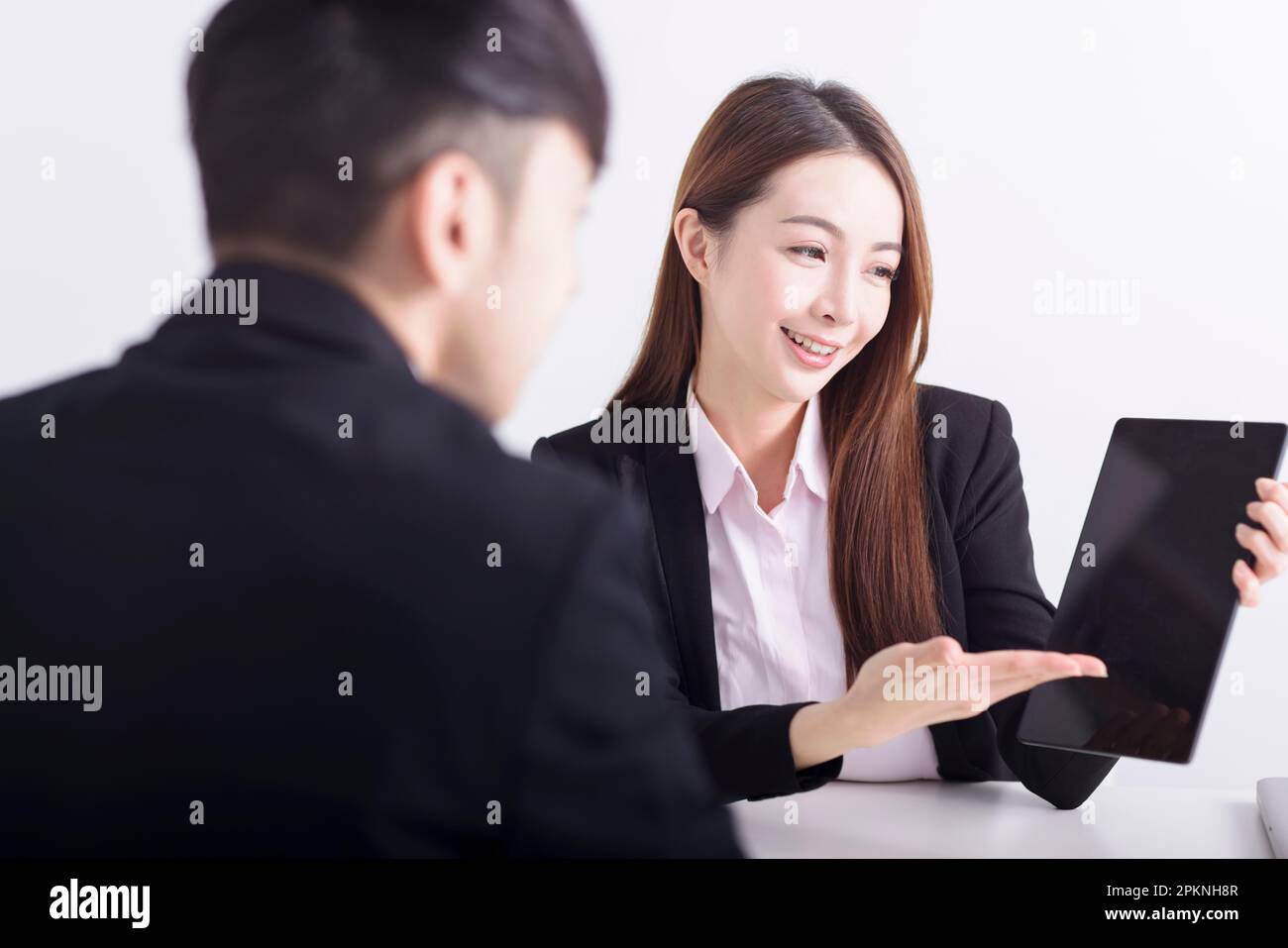 Businesswoman showing business plan with digital tablet pad in the office Stock Photo