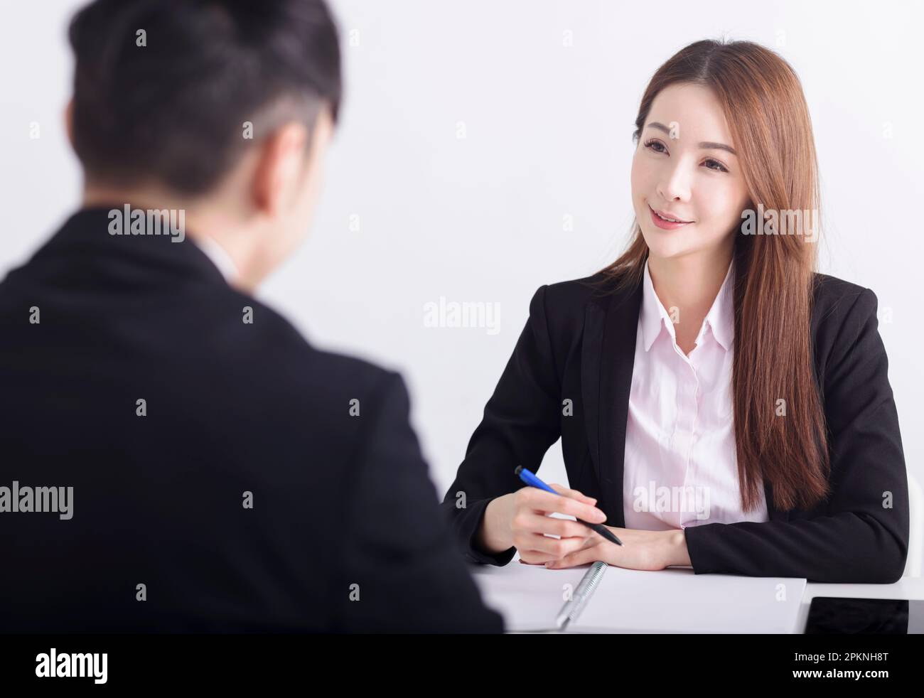 Business female manager interviewing young men job applicant in the office Stock Photo