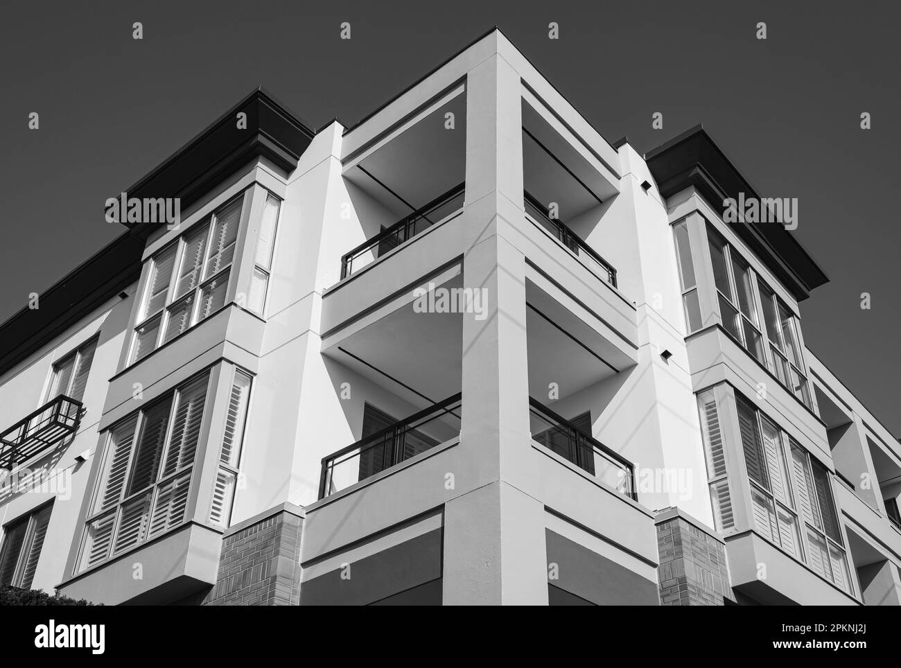 Modern and new apartment building. Multistoried modern, new and stylish living block of flats. Modern residential apartment with flat buildings exteri Stock Photo