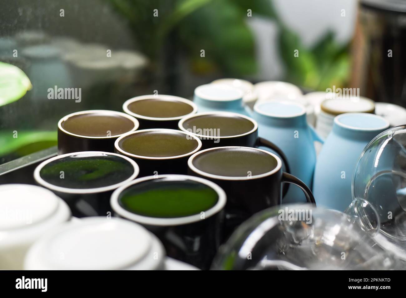 Many clean and washed mugs and cups in a row in kitchen with copy space