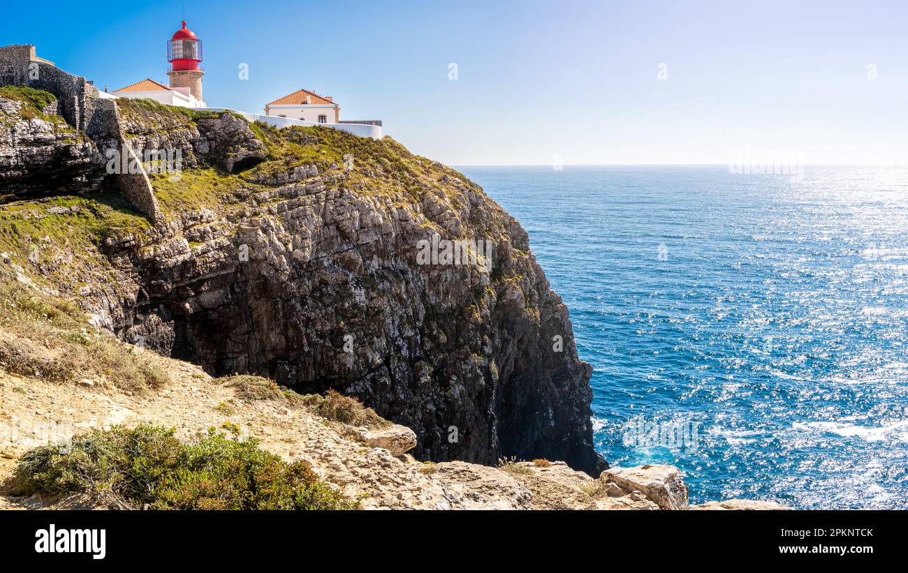 The lighthouse Farol do Cabo de São Vicente stands tall atop the majestic high cliff of Cabo de São Vicente headland, offering breathtaking views. Stock Photo
