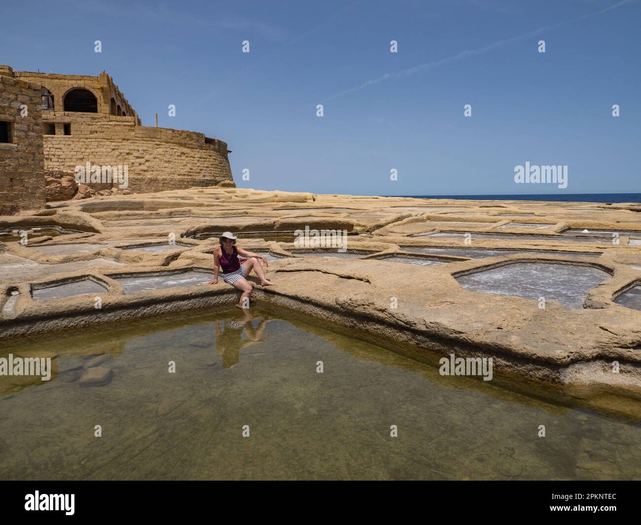 Salt evaporation ponds on the coast of the island of Gozo also called Salinas, salt pans, salt shakers used for traditional salt crafts. Salins de Mar Stock Photo