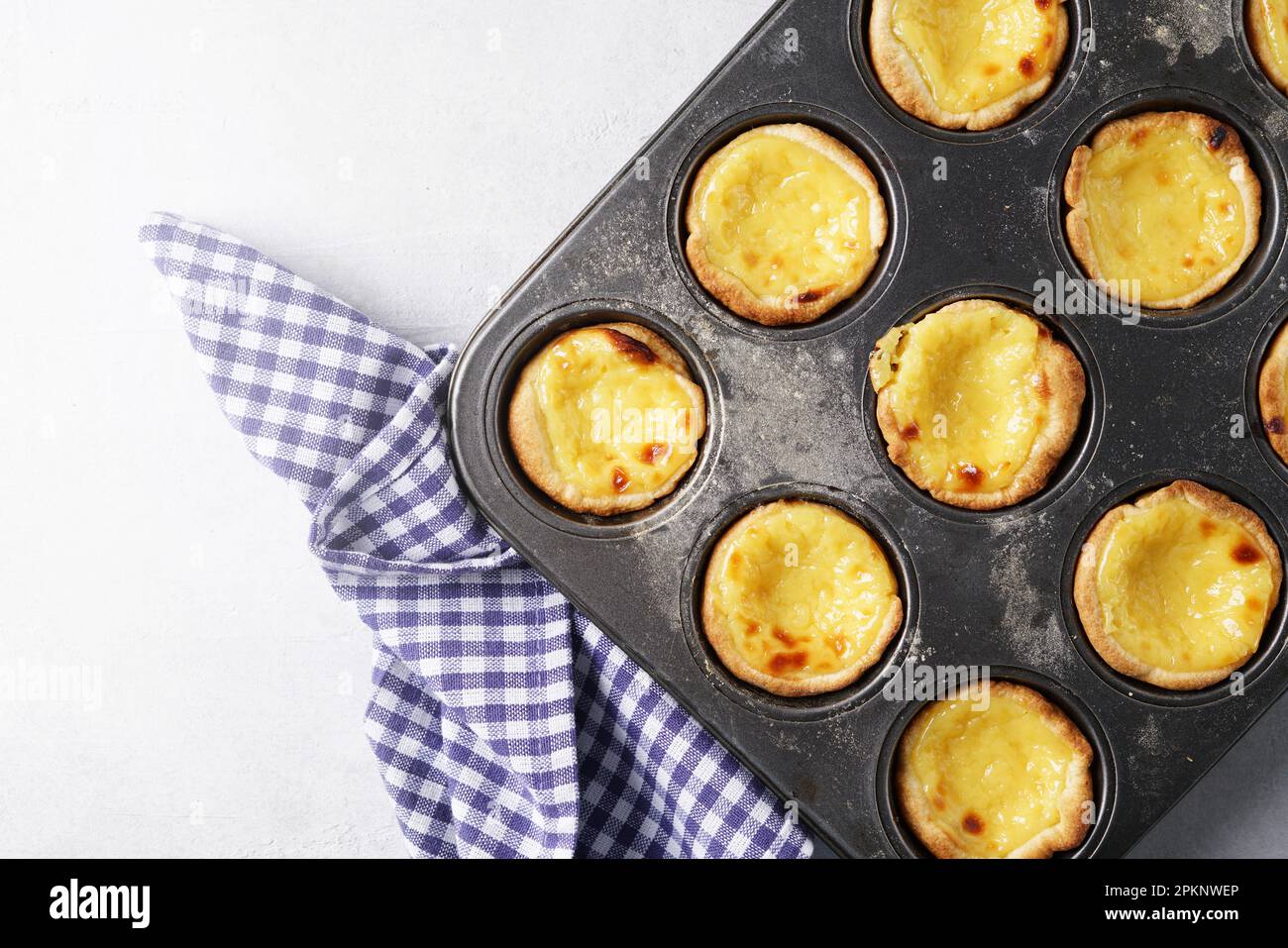 Pasteis de nata in the cooking form. Top view, copy space Stock Photo