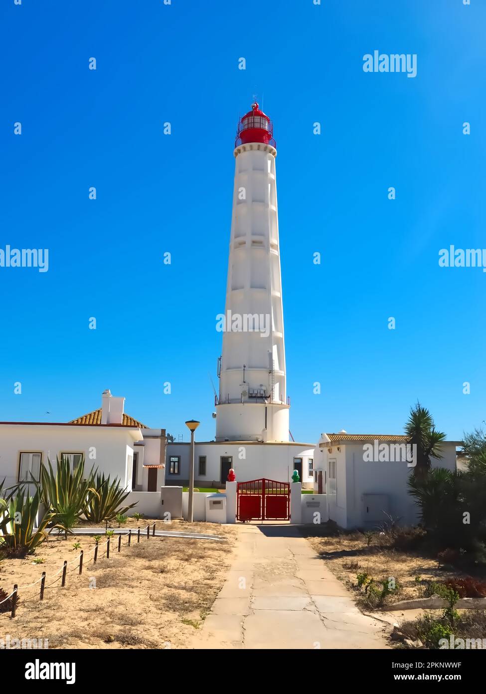 Lighthouse of the island Farol at the Algarve coast of Portugal Stock Photo
