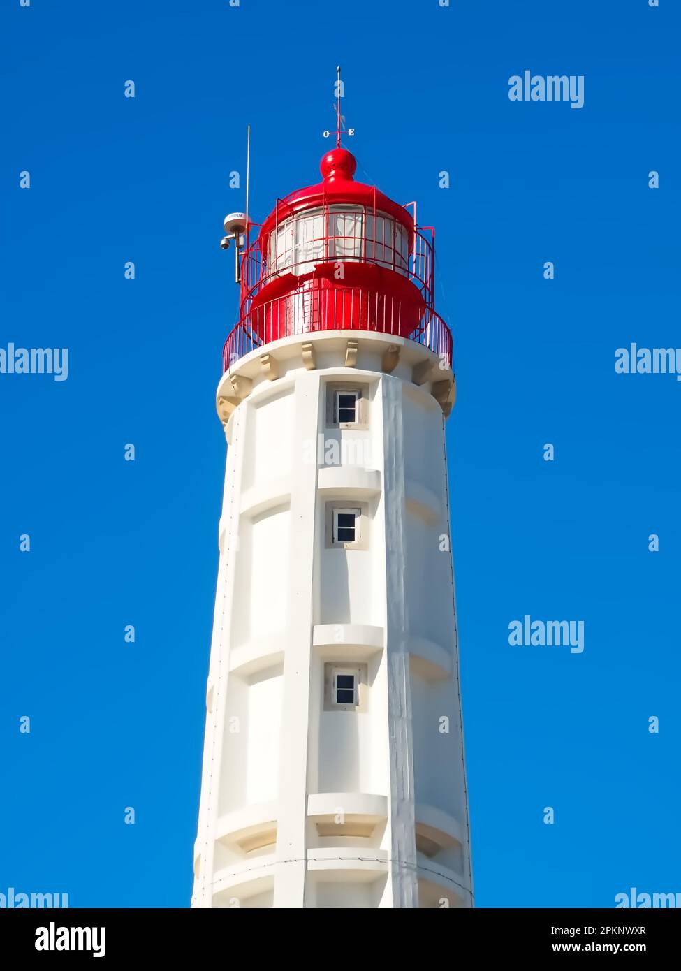 Lighthouse of the island Farol at the Algarve coast of Portugal Stock Photo