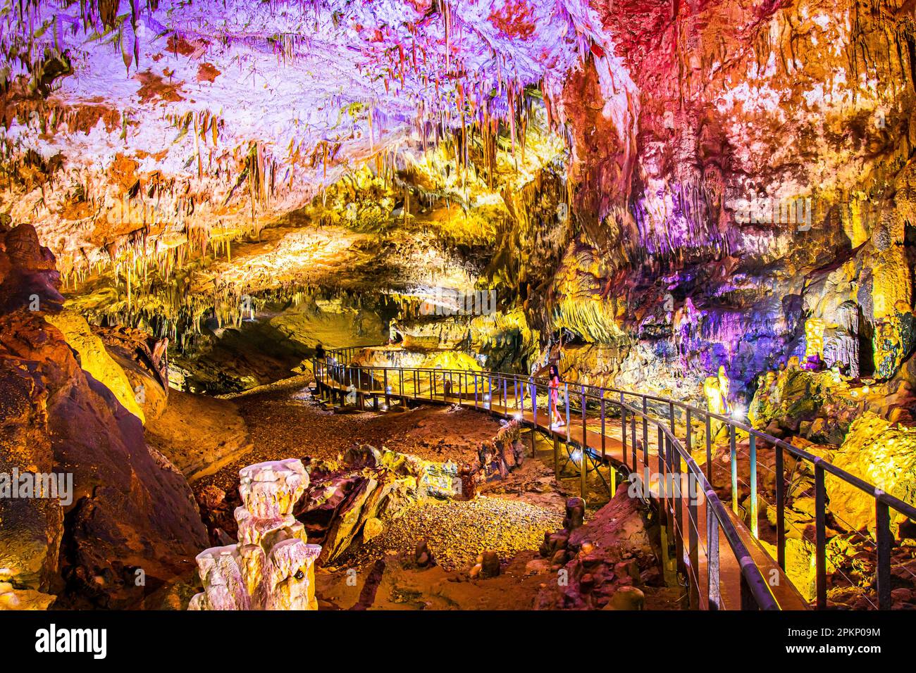 Pathway in Prometheus cave with beautiful colorful structures and formations Stock Photo