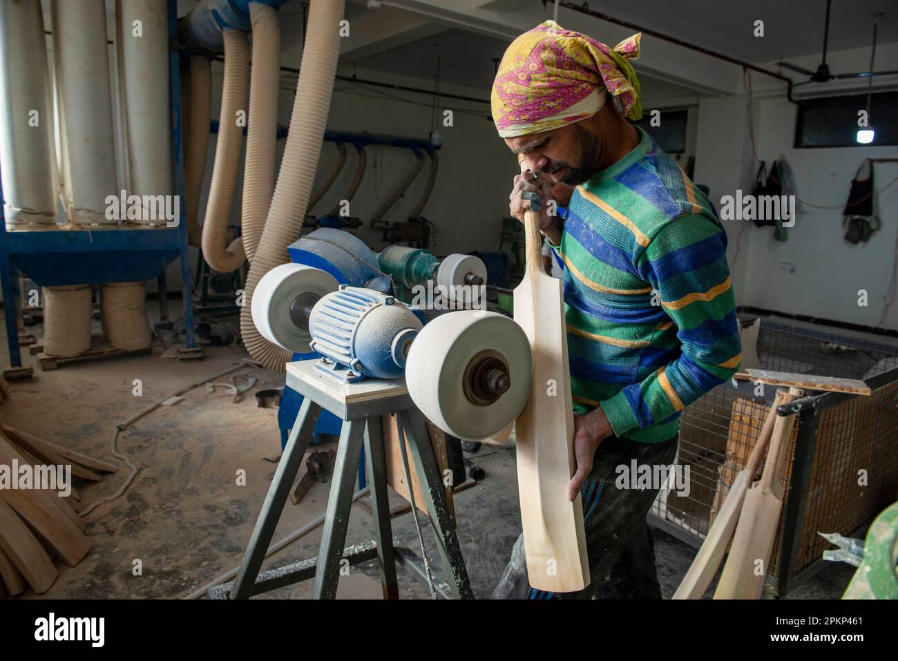 Meerut, India. 08th Apr, 2023. A worker shapes a cricket bat on a