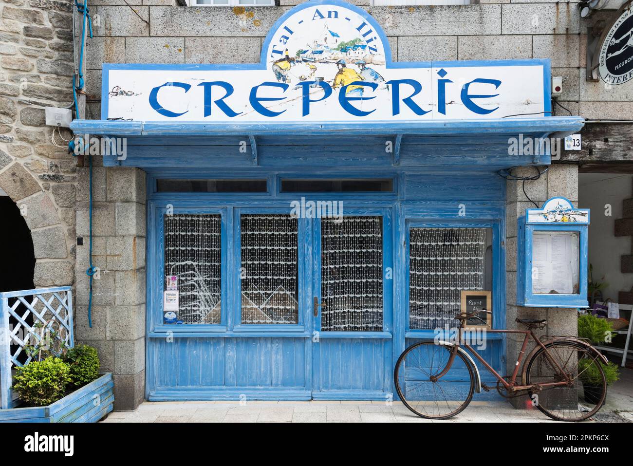 Old bicycle in front of a Creperie, Roscoff, Brittany, France, Europe Stock Photo