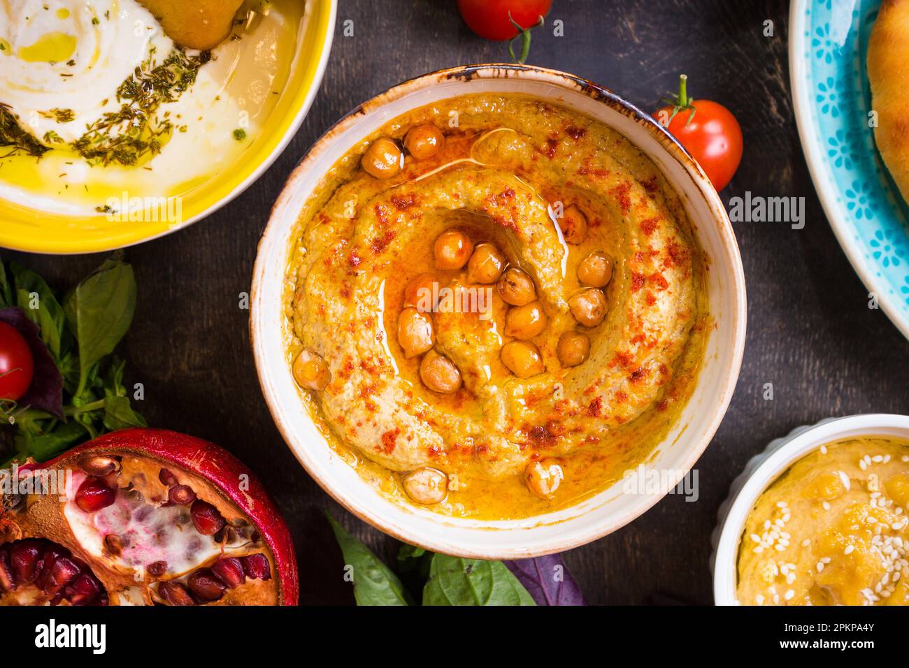 Hummus plate closeup. Hummus, tahini, pitta and buttermilk dip with