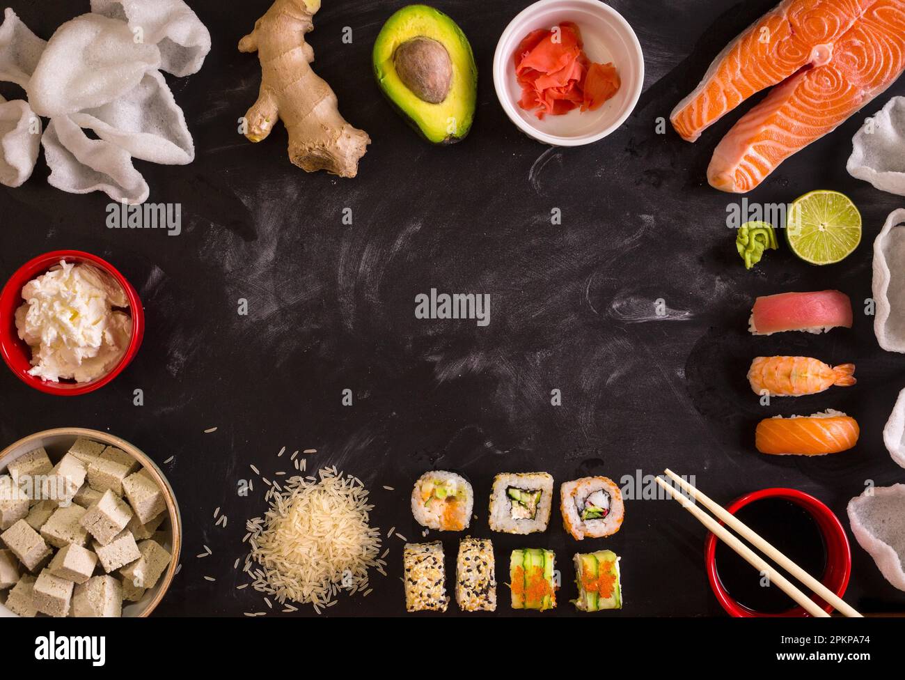 overhead-shot-of-sushi-and-ingredients-on-dark-background-sushi-rolls