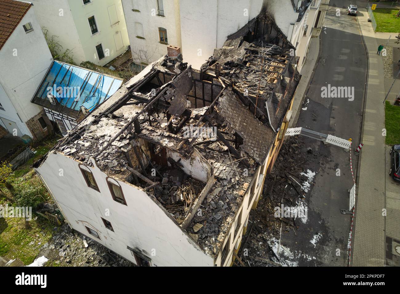 Koblenz, Germany. 03rd Apr, 2023. Two residential buildings in the Koblenz district of Pfaffendorf are totally destroyed after a fire.Two residents were rescued by the fire department and hospitalized. (Aerial photograph taken with a drone) Credit: Thomas Frey/dpa/Alamy Live News Stock Photo