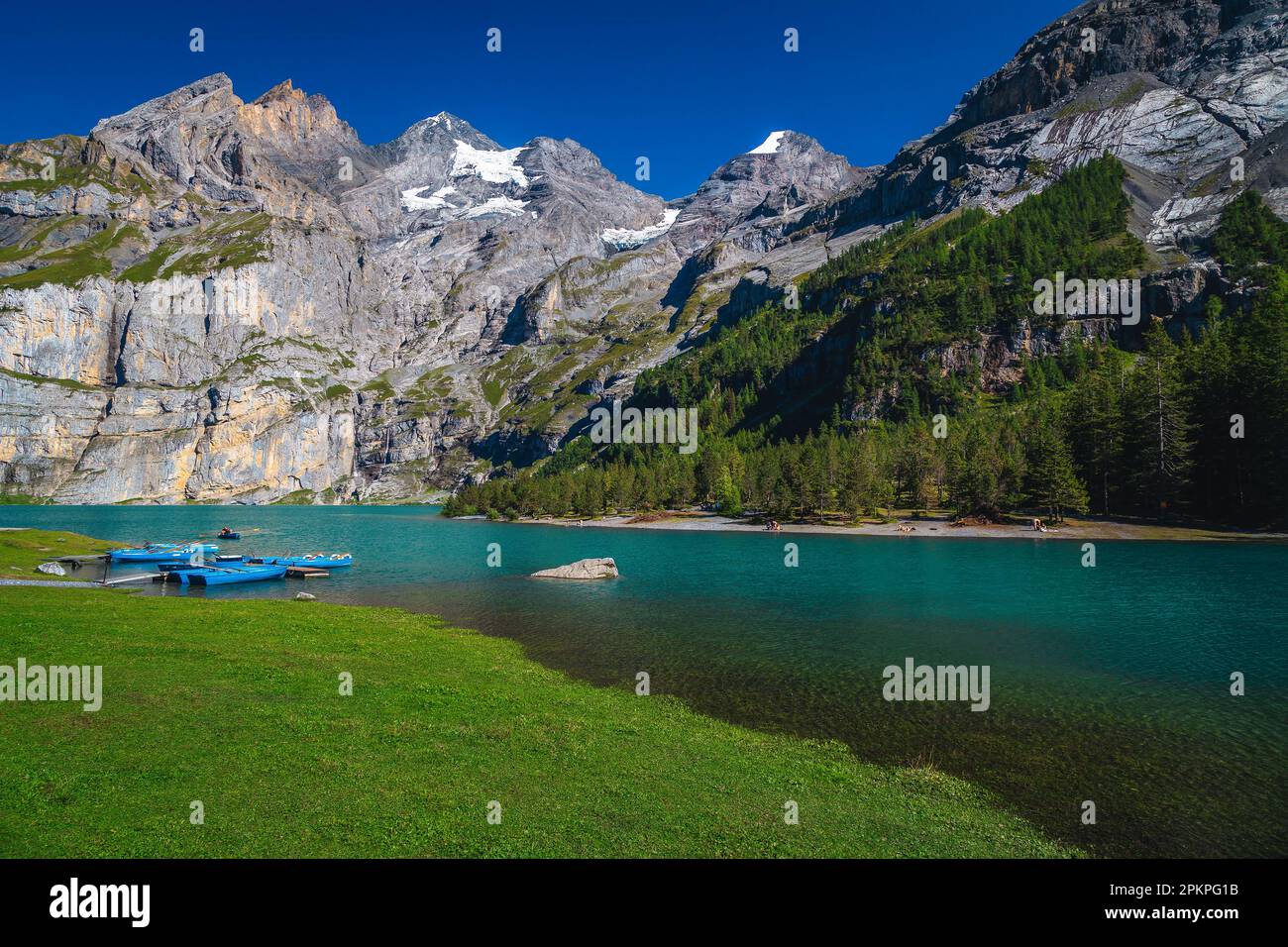 Great hiking and recreation place with lake Oeschinensee. Moored wooden ...