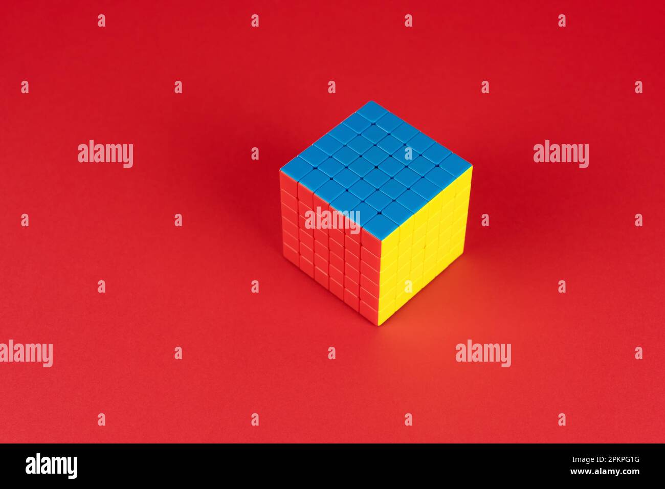 Colorful puzzle cube on red background Stock Photo