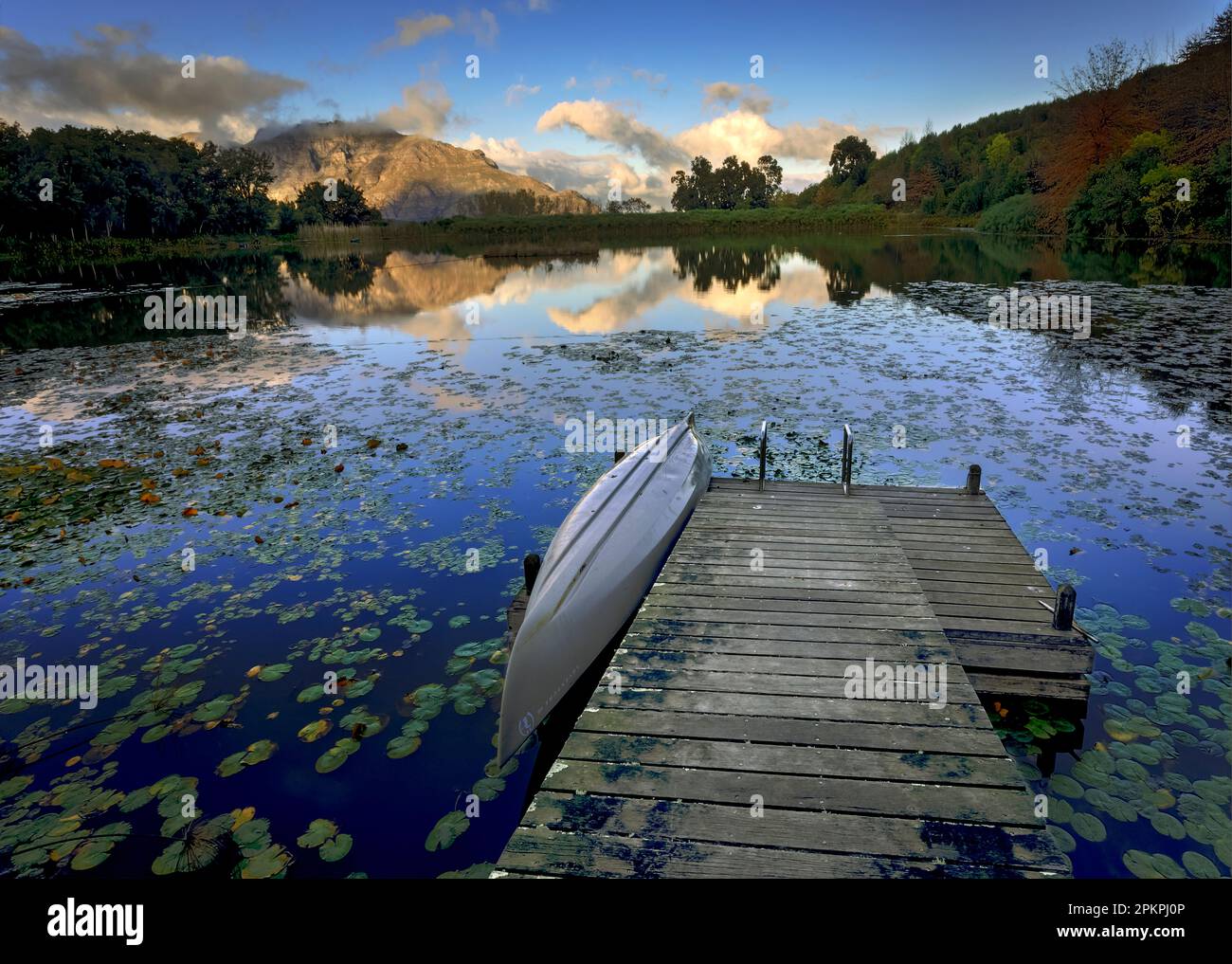 Boat ramp and reflection of Stellenbosch mountain on Tokara dam. Stock Photo