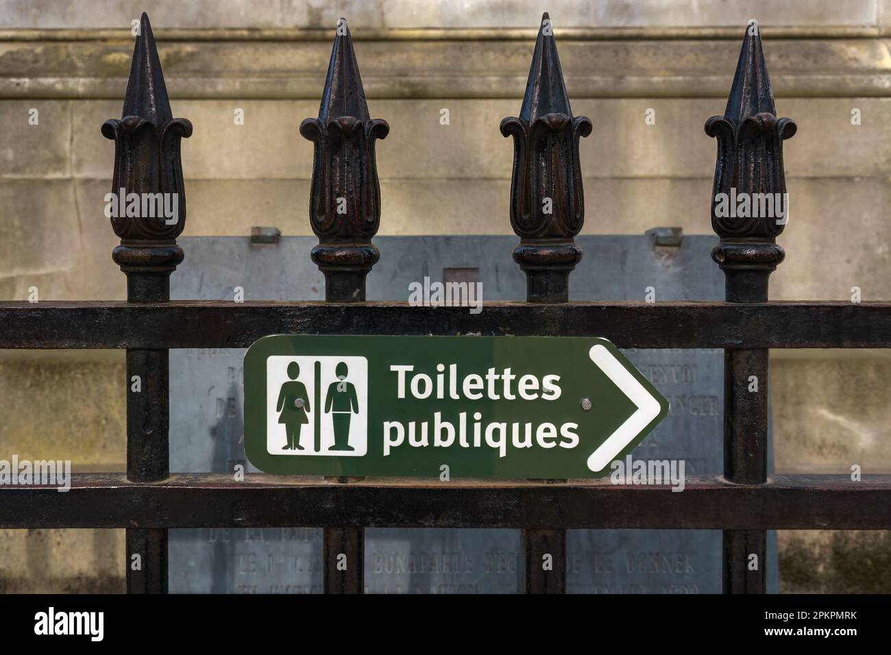 Green public toilet sign in French on a fence in Paris, France. Stock Photo