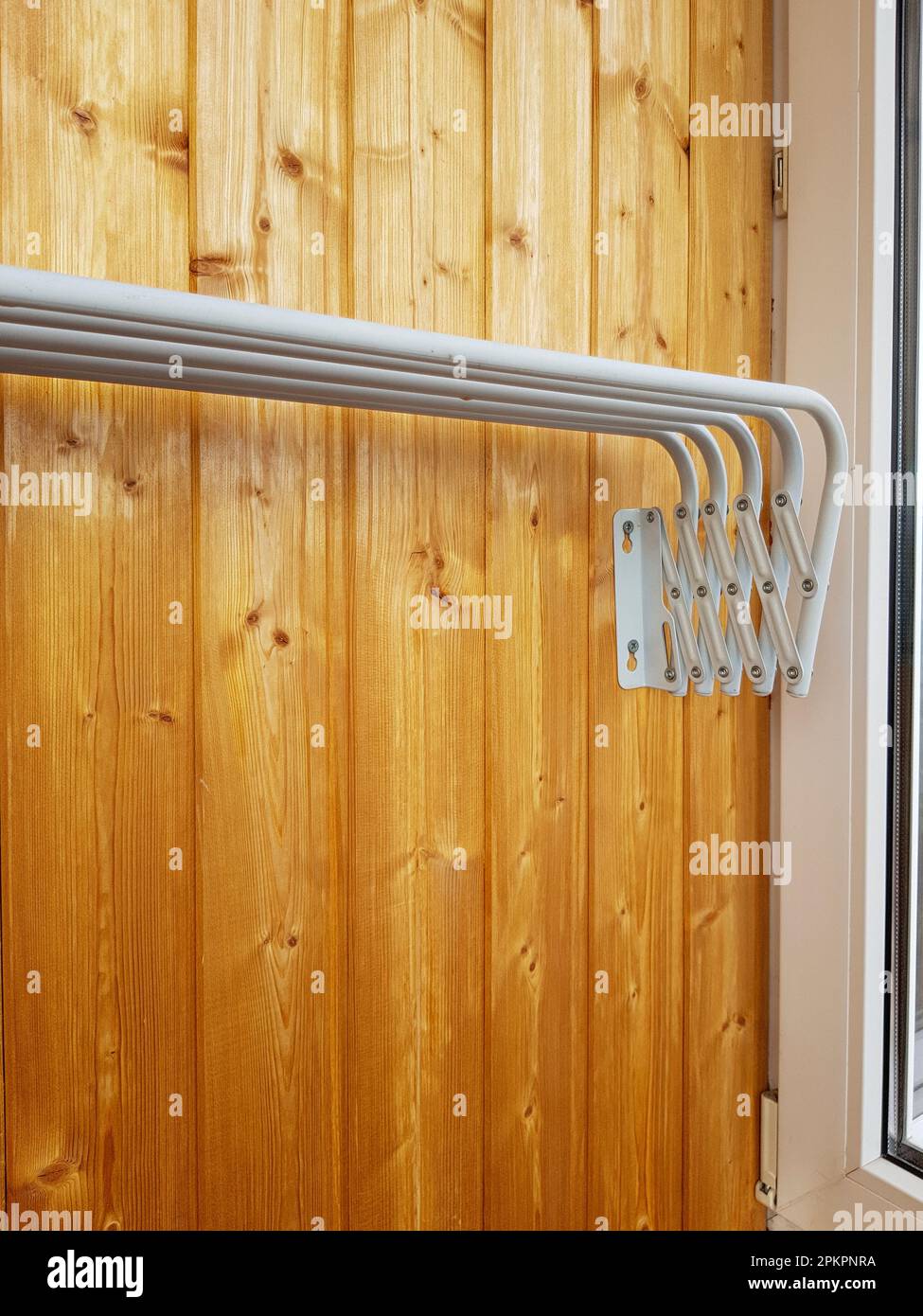 clothes dryer folded, attached to a wooden wall, vertical Stock Photo