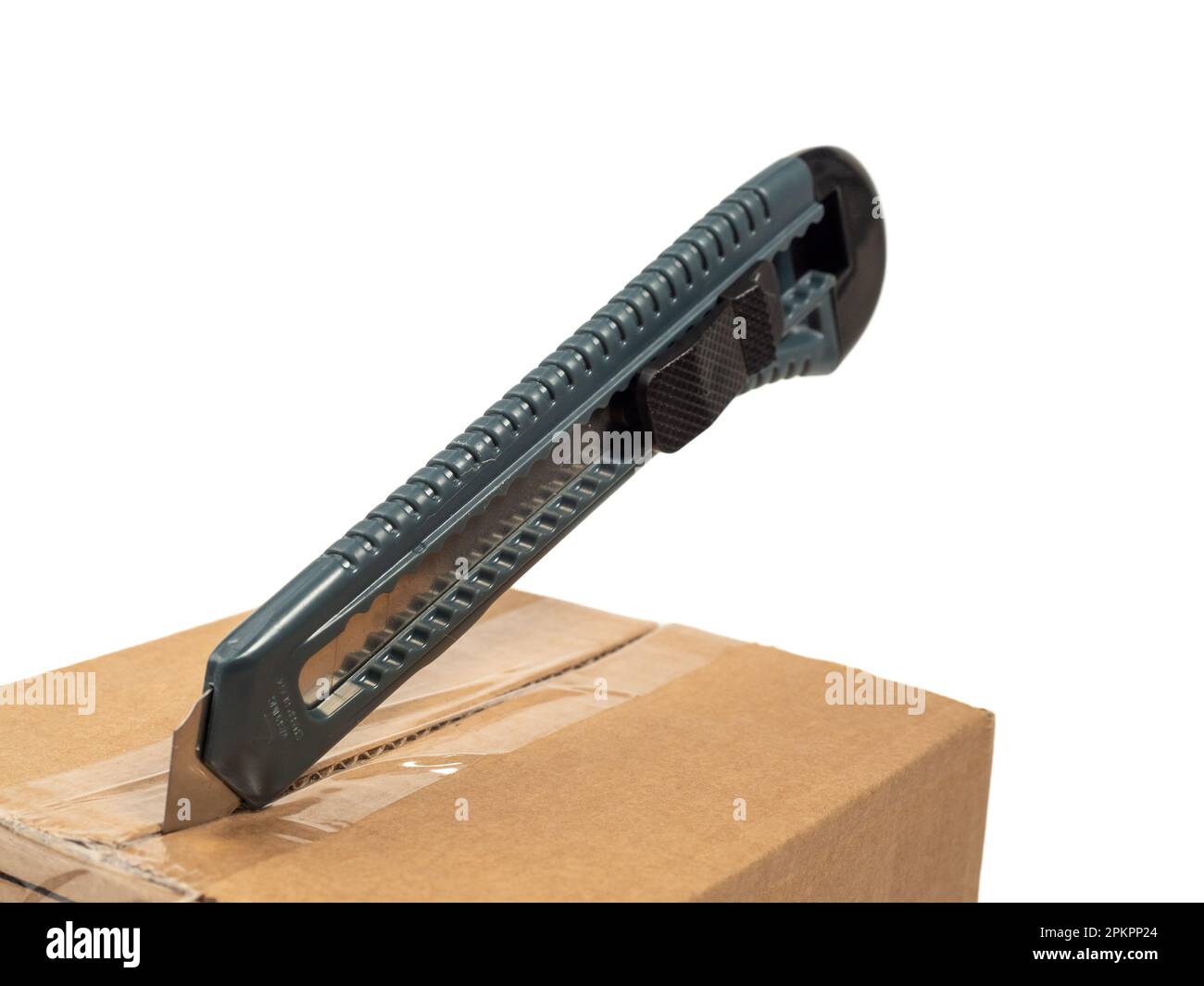The cardboard box is opened with a knife. White background Stock Photo