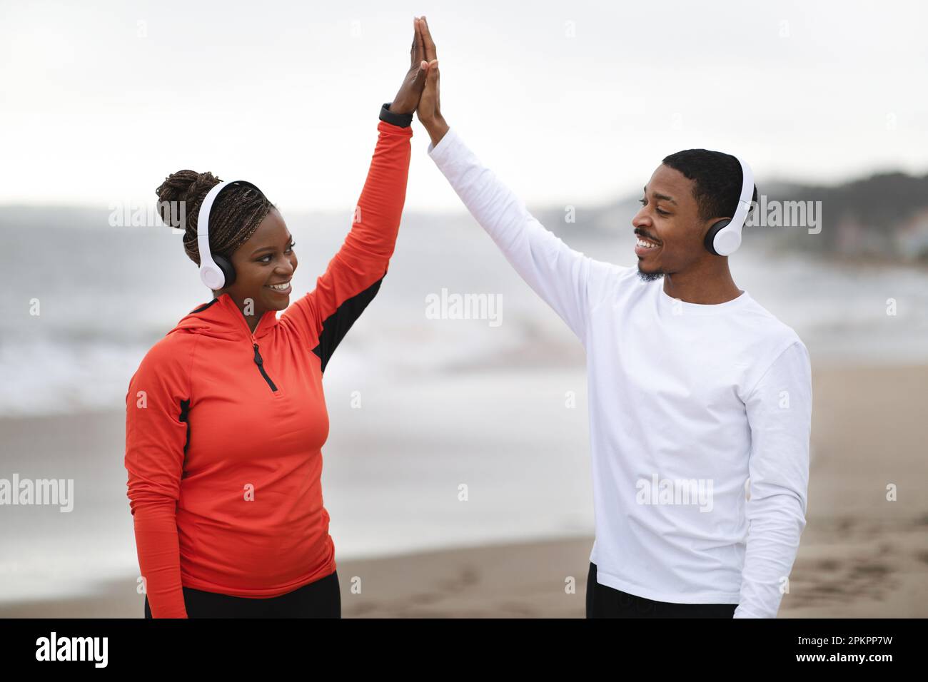 Cheerful millennial african american couple in sportswear and ...