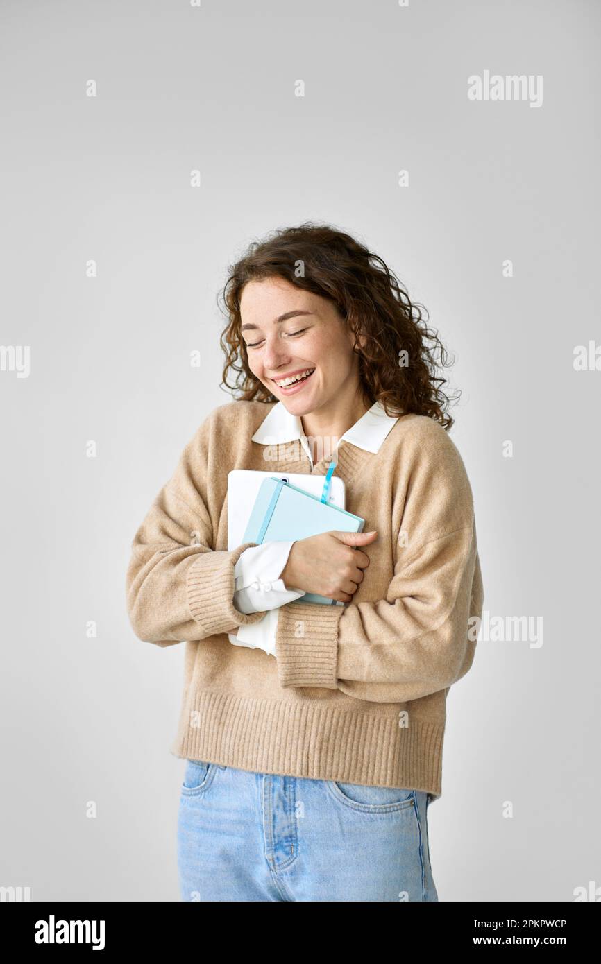 Young pretty cute girl student holding digital tablet feeling happy. Stock Photo