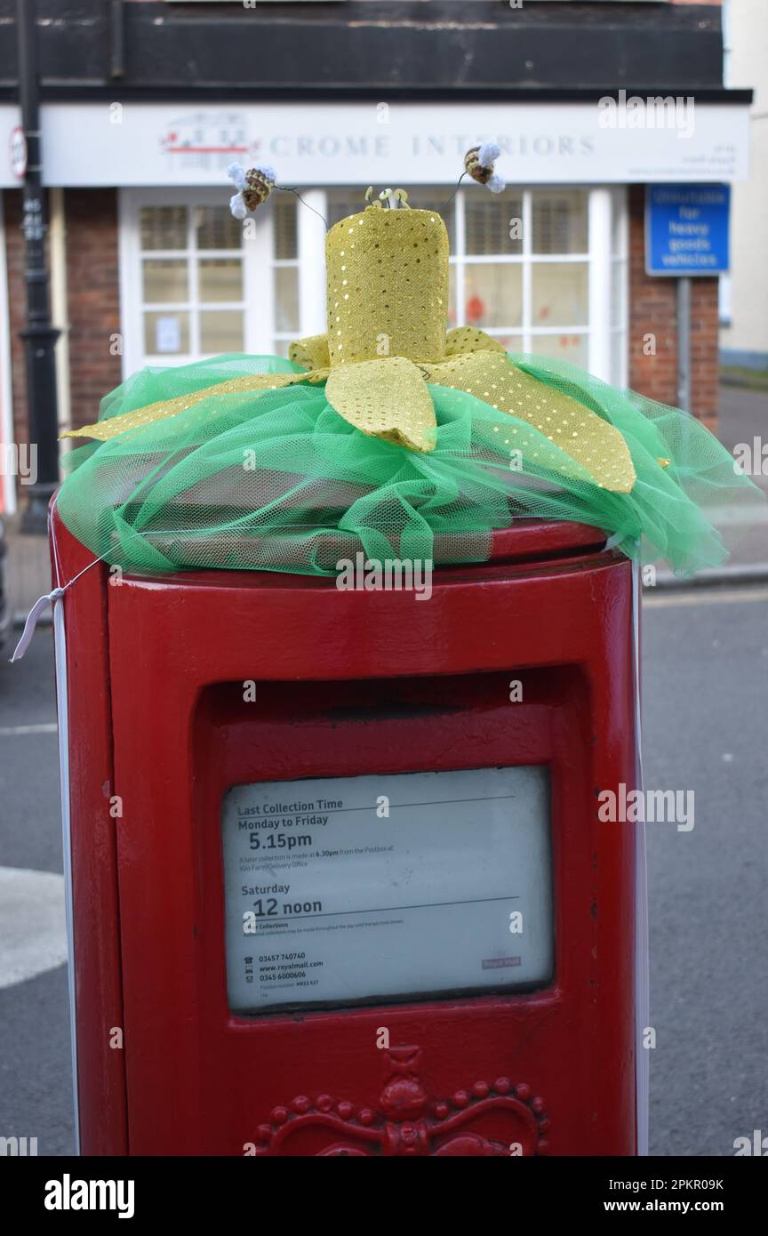 A spring post box topper with a flower and bees in Stony Stratford, Milton Keynes. Stock Photo
