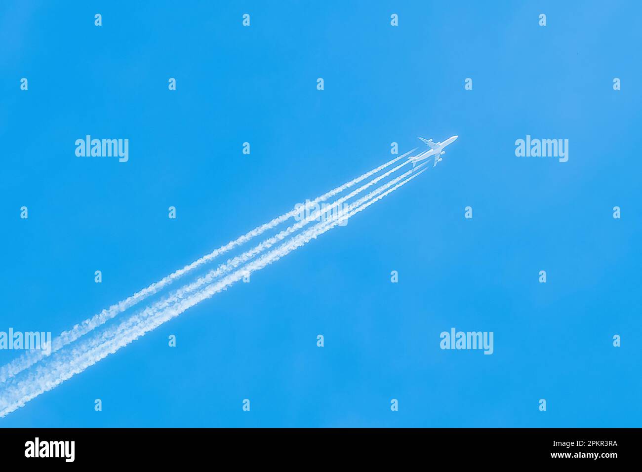 Jet in the blue sky. Diagonal view. Aircraft travel. Stock Photo