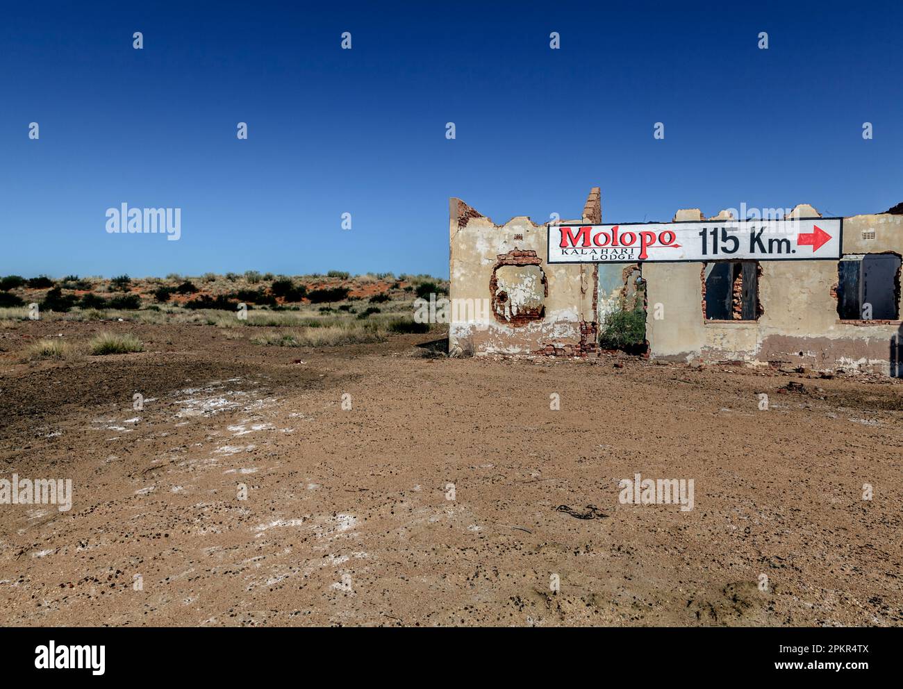 A sign to a Kalahari Desert lodge is painted on a abandoned house along the R31 road between Upington and the Niminian boder at Rietfontein. Stock Photo