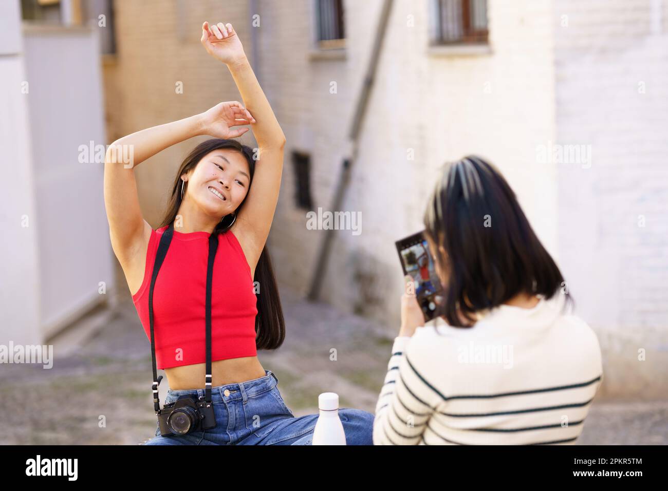 Asian woman posing together hi-res stock photography and images - Alamy