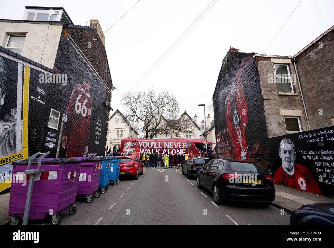 The Liverpool team bus is seen passing player murals on Sybil Road as