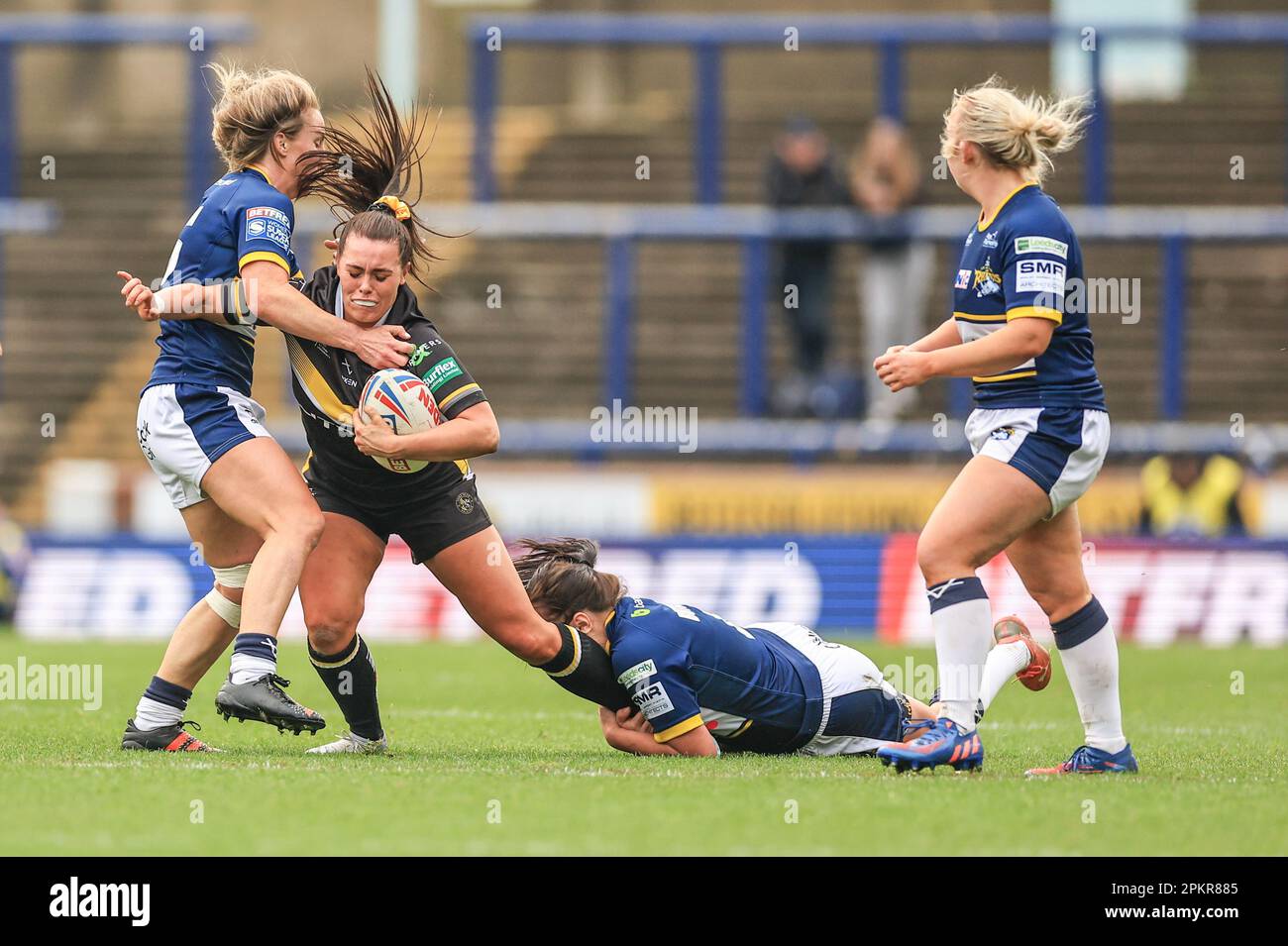 Lacey Owen of York Valkyrie is tackled by Bethan Dainton of Leeds Rhinos and Hanna Butcher of Leeds Rhinos during the Betfred Women's Super League match Leeds Rhinos vs York Valkyrie at Headingley Stadium, Leeds, United Kingdom, 9th April 2023  (Photo by Mark Cosgrove/News Images) Stock Photo