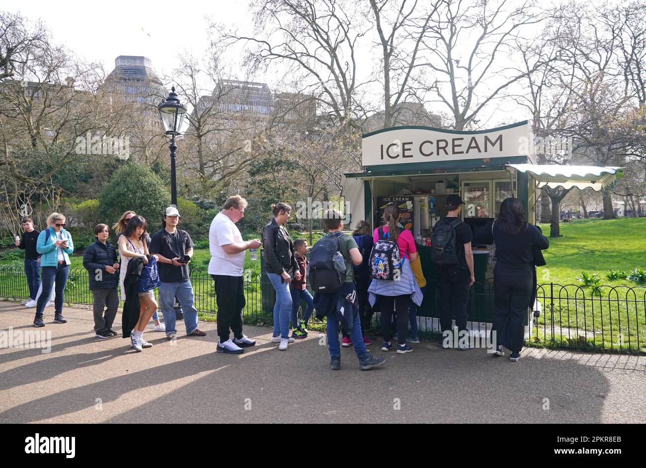People queue for ice creams in St James's Park in London. Picture date