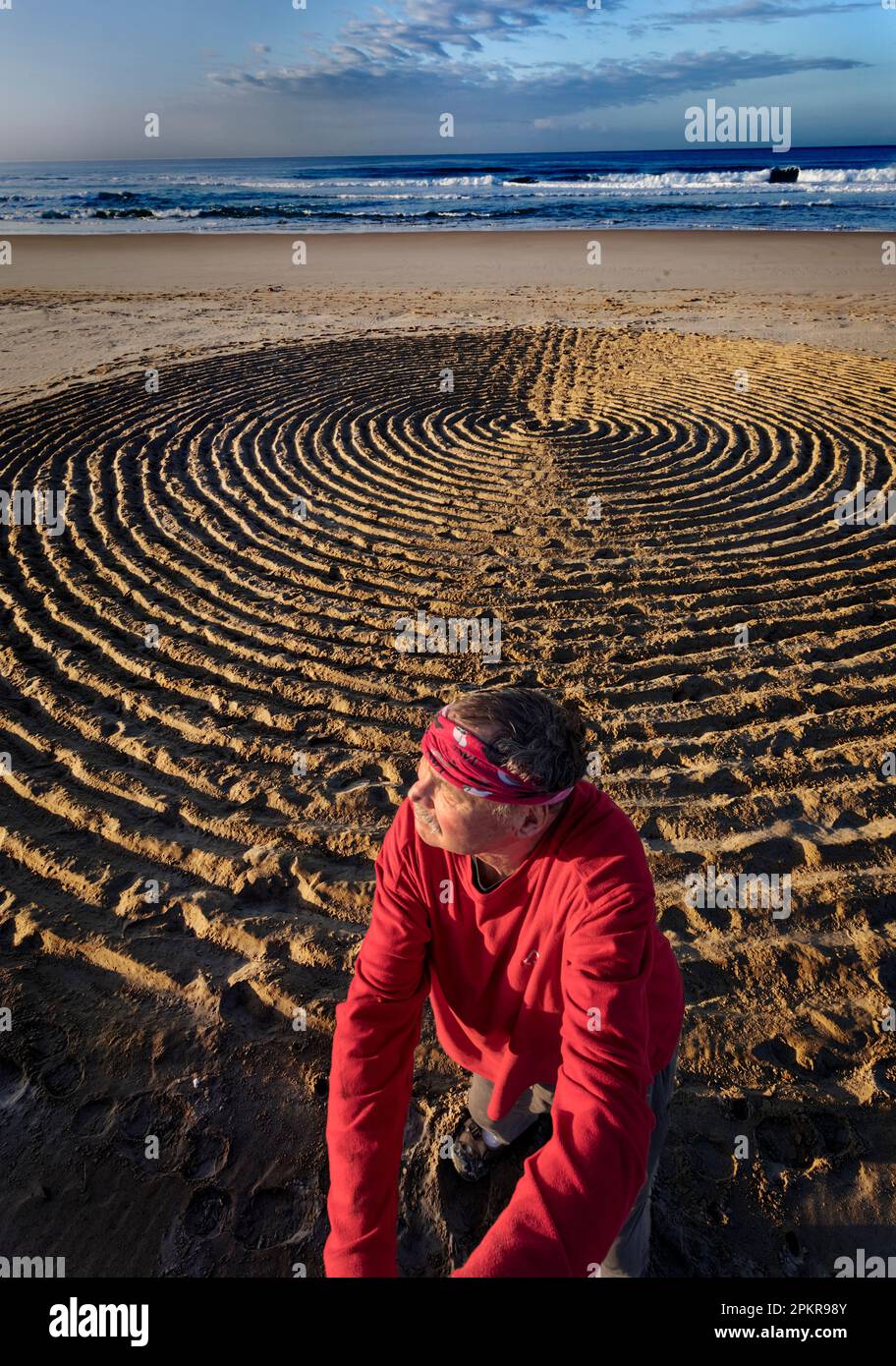 Man with beach art installation on the Natures Valley beach Stock Photo