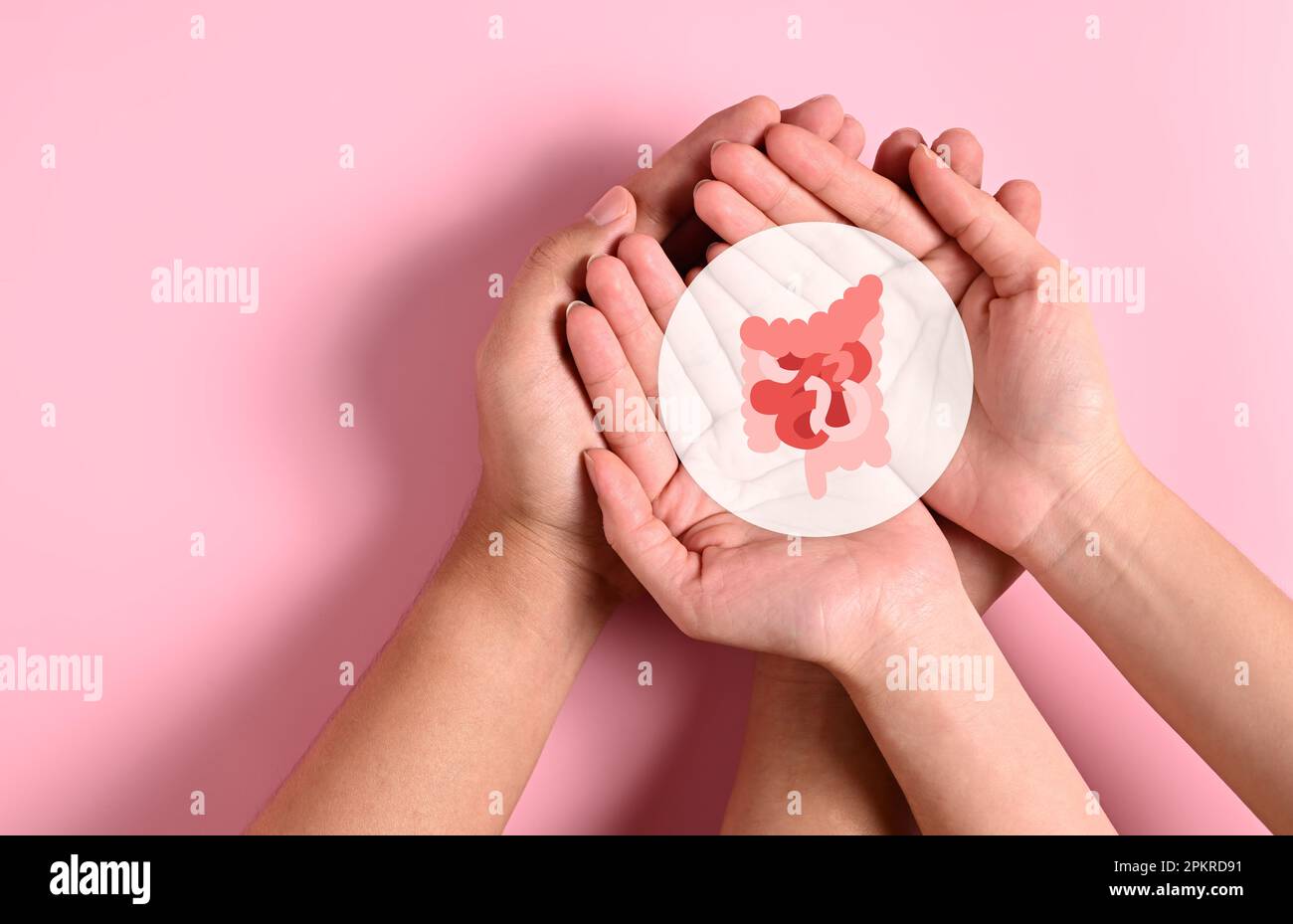 People holding virtual intestine icon on hands with pink background ...