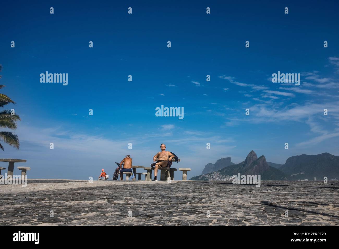 Retired man enjoys a sunny morning at Arpoador beach. Rio de Janeiro, Brazil. Stock Photo