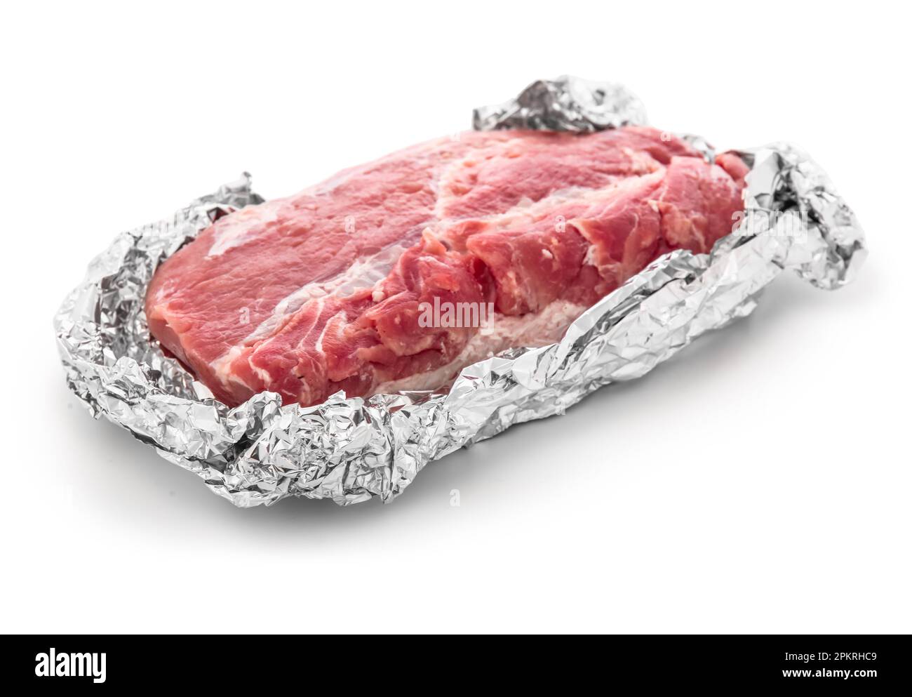 Piece of raw meat wrapped in aluminium foil on white background Stock