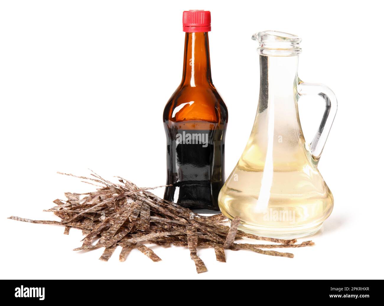 Bottles of rice vinegar, soy sauce and cut nori sheets on white