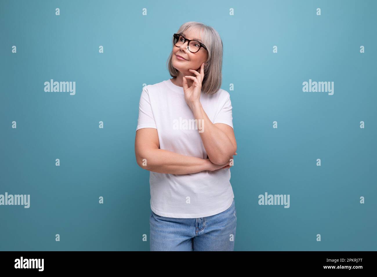 mature woman in gray hair being premenopausal in studio background