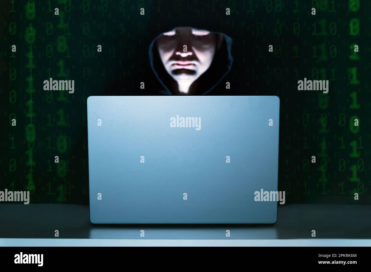 Hacker sitting in front of the laptop at night, low light with zero and ...