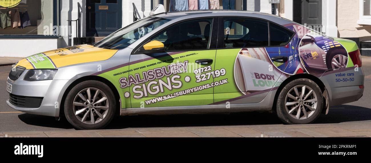 Salisbury, Wiltshire, England, UK. 2023. A local taxi advertising with