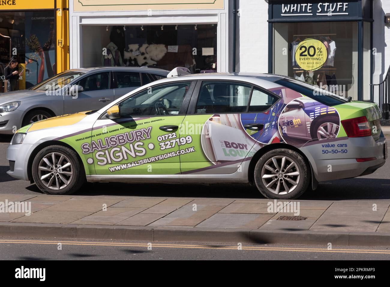 Salisbury, Wiltshire, England, UK. 2023. A local taxi advertising with