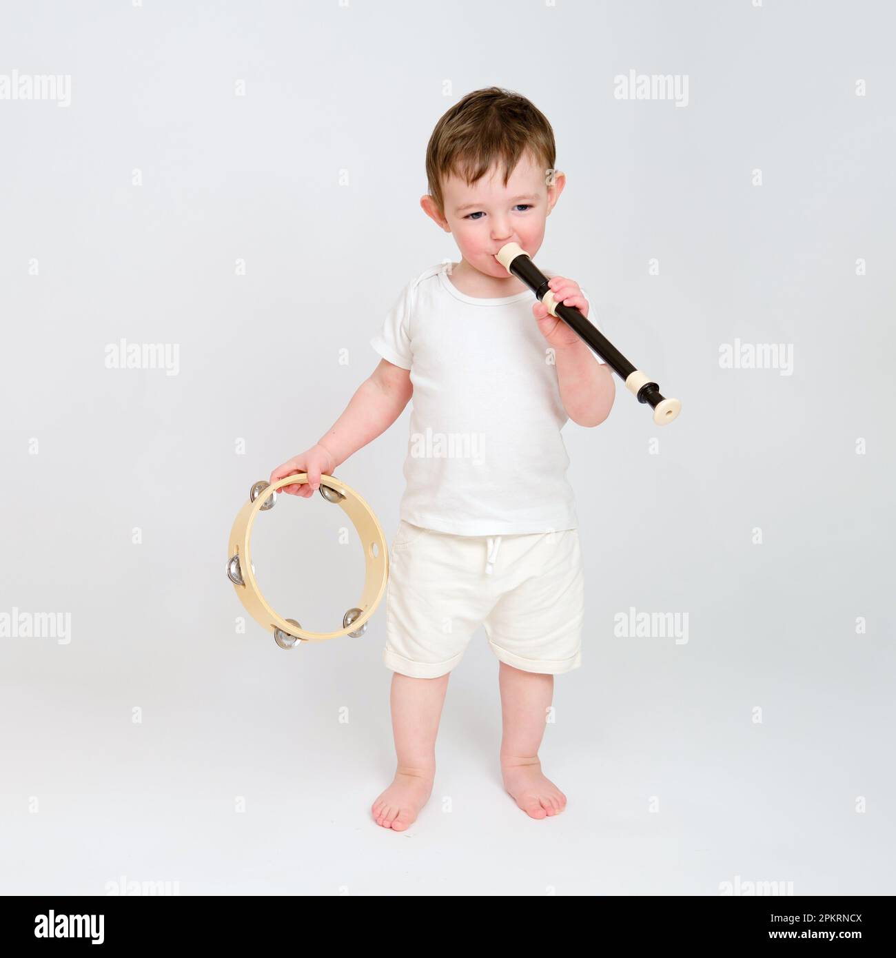 Standing smiling playing musical instrument childhood hi-res stock ...