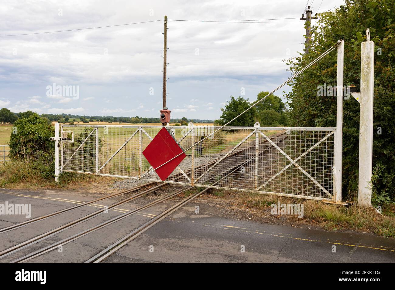 Tenterden, Kent, united kingdom, 21, August, 2022 vintage level crossing barriers across the road to allow train to safely pass Stock Photo