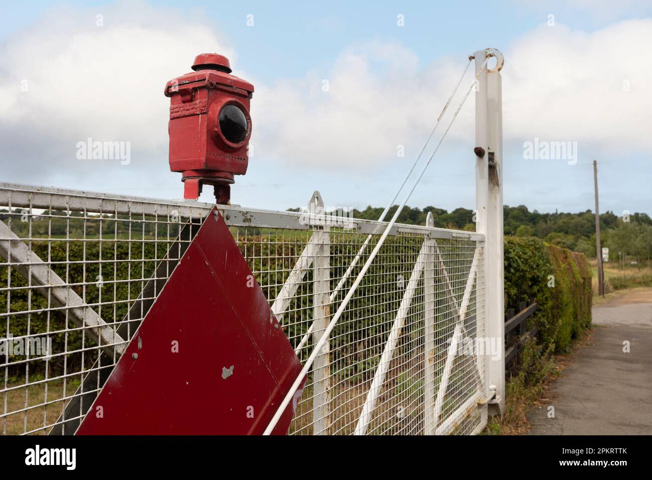 Close-up view of a vintage stop lantern seen atop an old railway level crossing Stock Photo