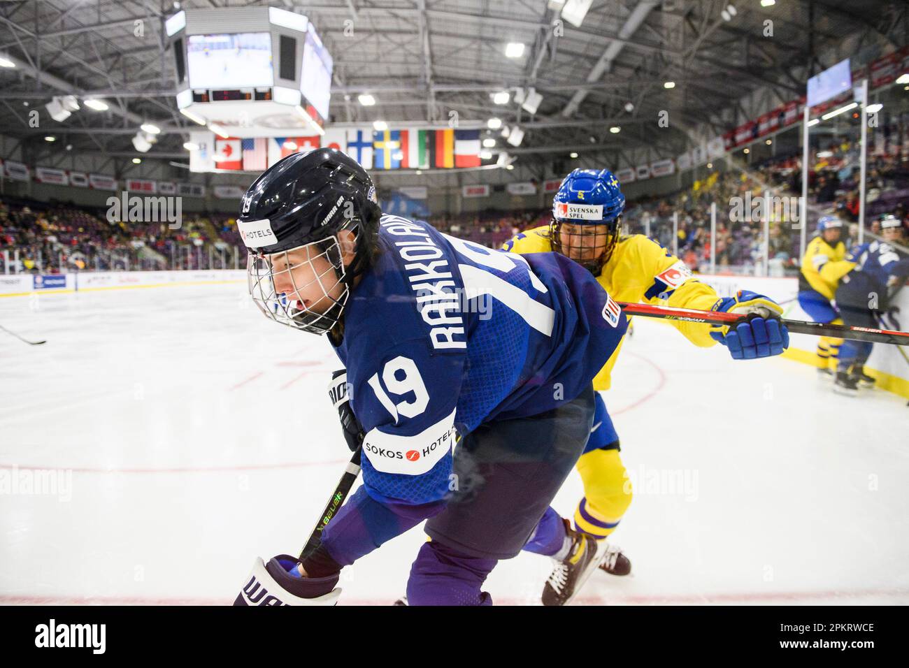Sweden defender Annie Silen (5) checks Finland forward Emmi Rakkolainen (19) during third period of the IIHF Womens World Hockey Championship hockey game in Brampton, Ont., on Sunday, April 9, 2023