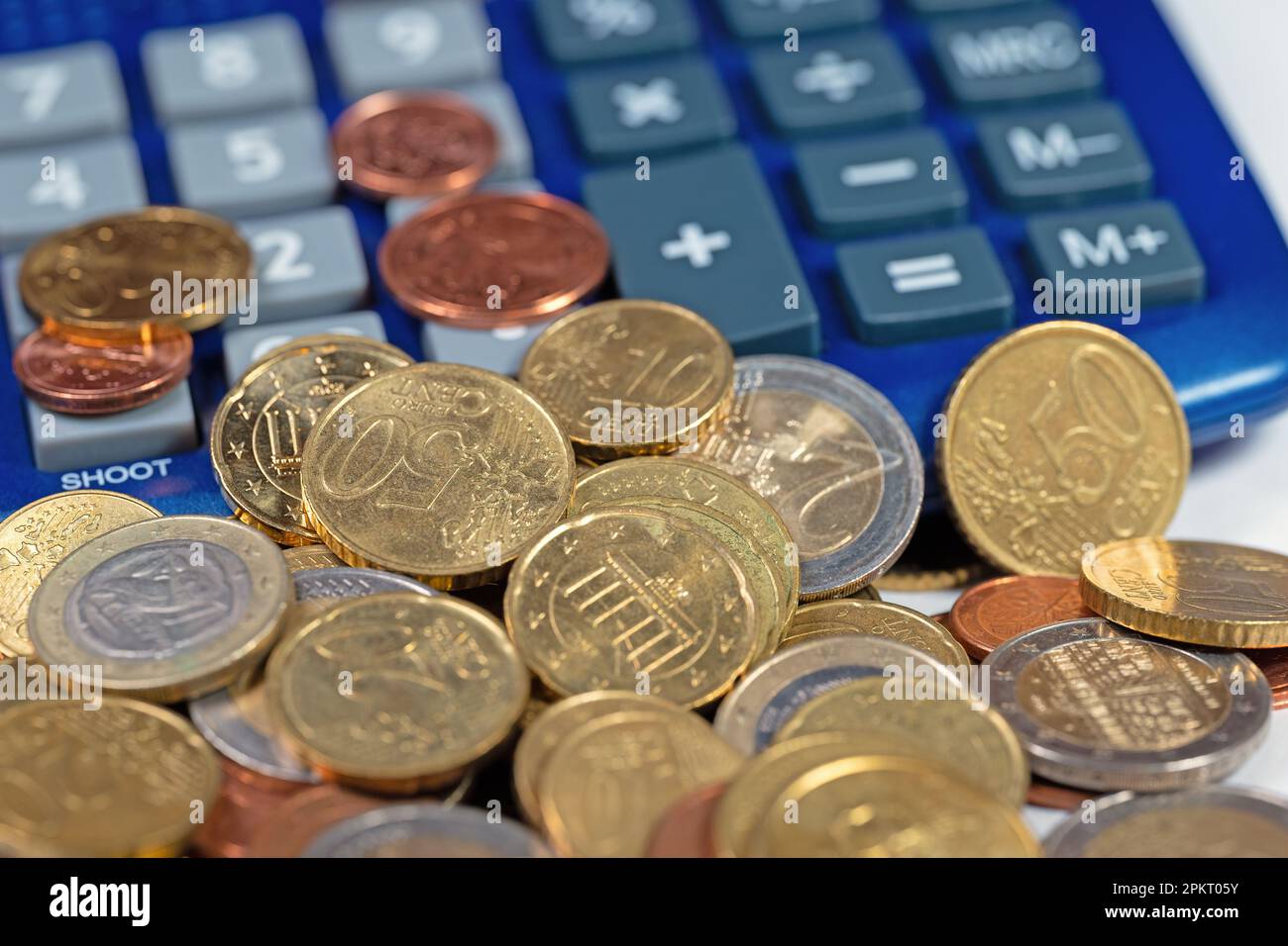 Euro coins and calculator in a close-up Stock Photo