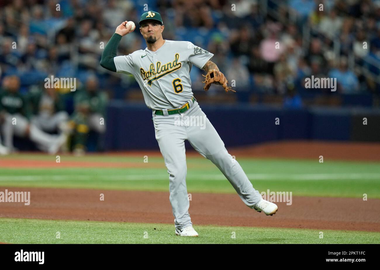 Oakland Athletics third baseman Jace Peterson, left, chases down a grounder  as Athletics shortstop Aledmys Diaz, right, looks on during the first  inning of a spring training baseball game against the San