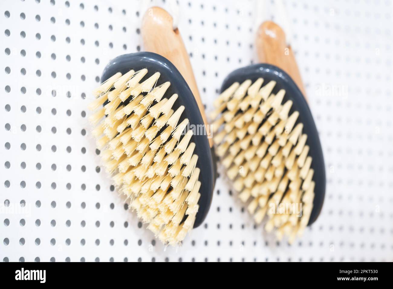 kitchen brushes hang in supermarket Stock Photo